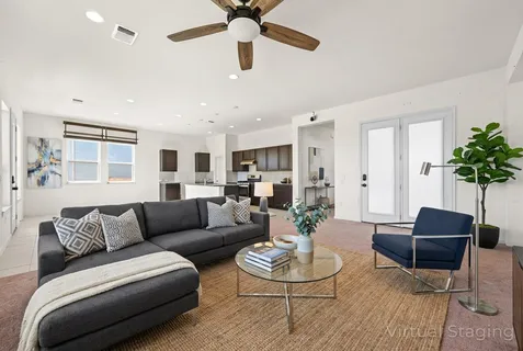 a living room with furniture potted plant and a window