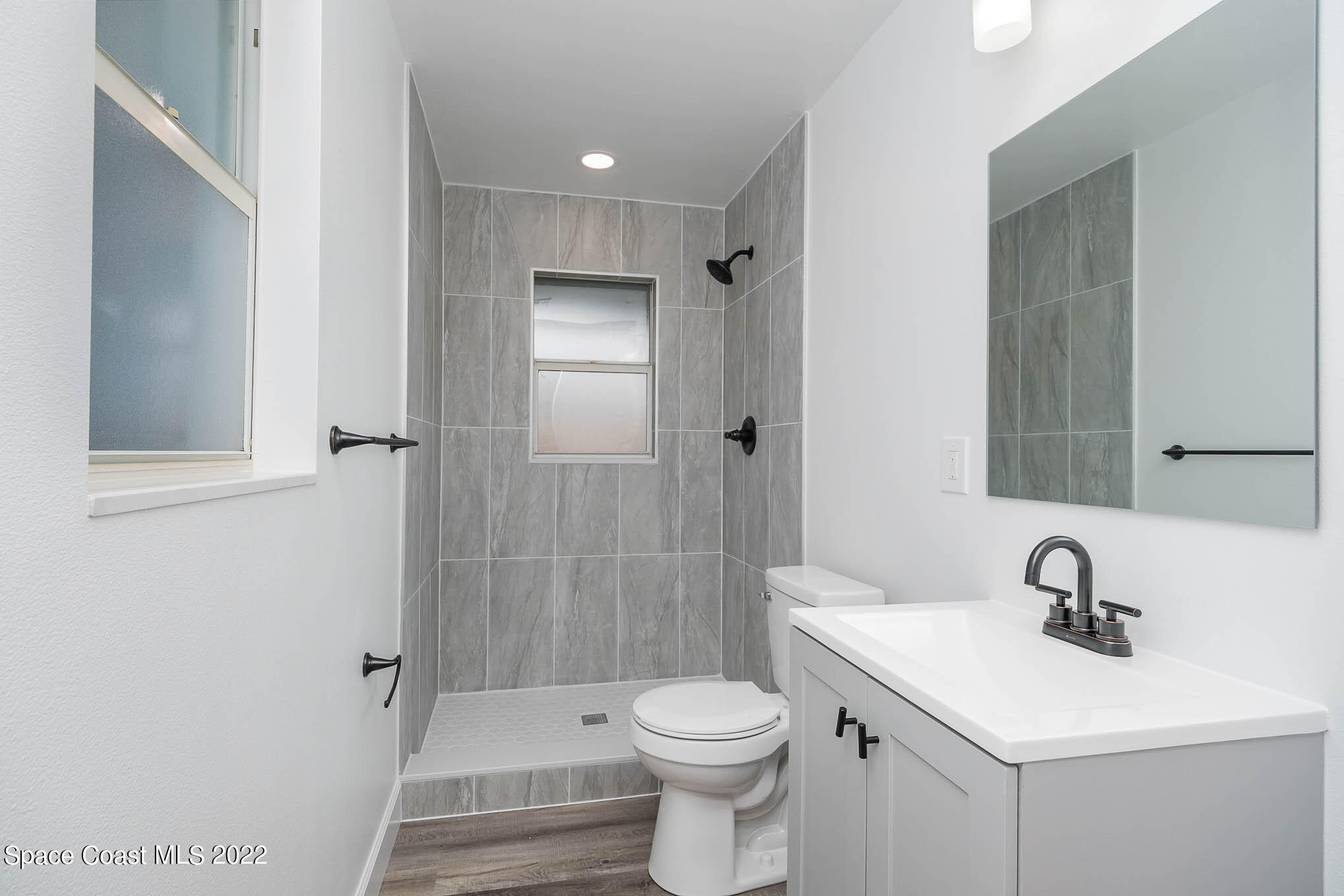 1026 Macco Road Cocoa, FL 32927 - Photo 11 of 20 a bathroom with a sink toilet and shower