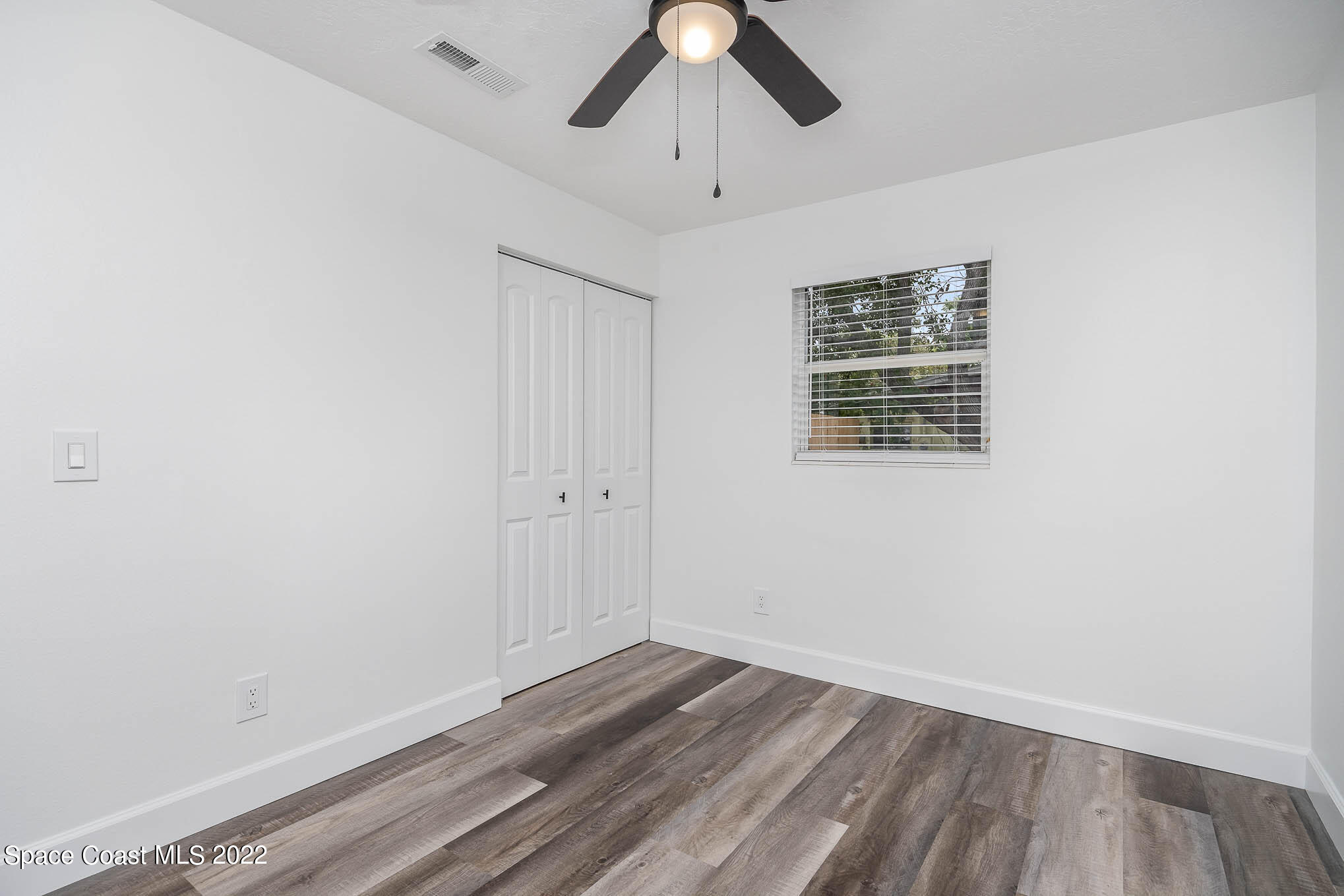 1026 Macco Road Cocoa, FL 32927 - Photo 14 of 20 a view of an empty room with wooden floor