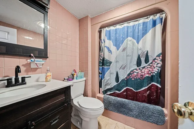 a bathroom with a sink mirror and toilet