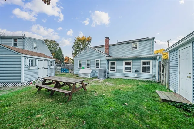 a backyard of a house with table and chairs