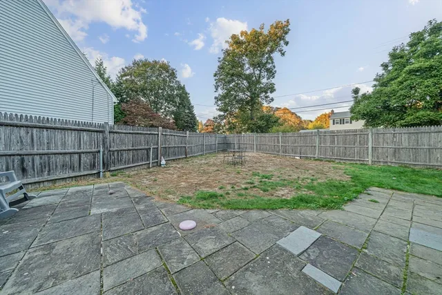 a view of a backyard with a wooden fence