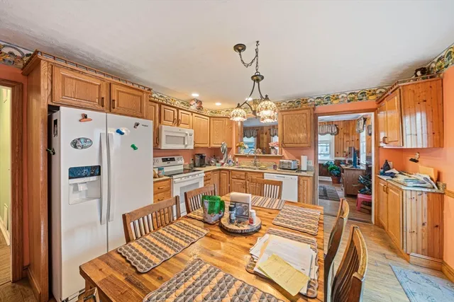 a view of a dining room with furniture a chandelier and wooden floor