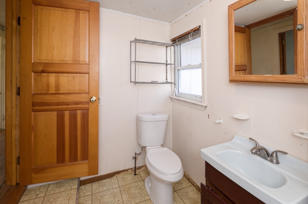 7 Cross Street Natick, MA 01760 - Photo 23 of 31 a bathroom with a sink a toilet and mirror