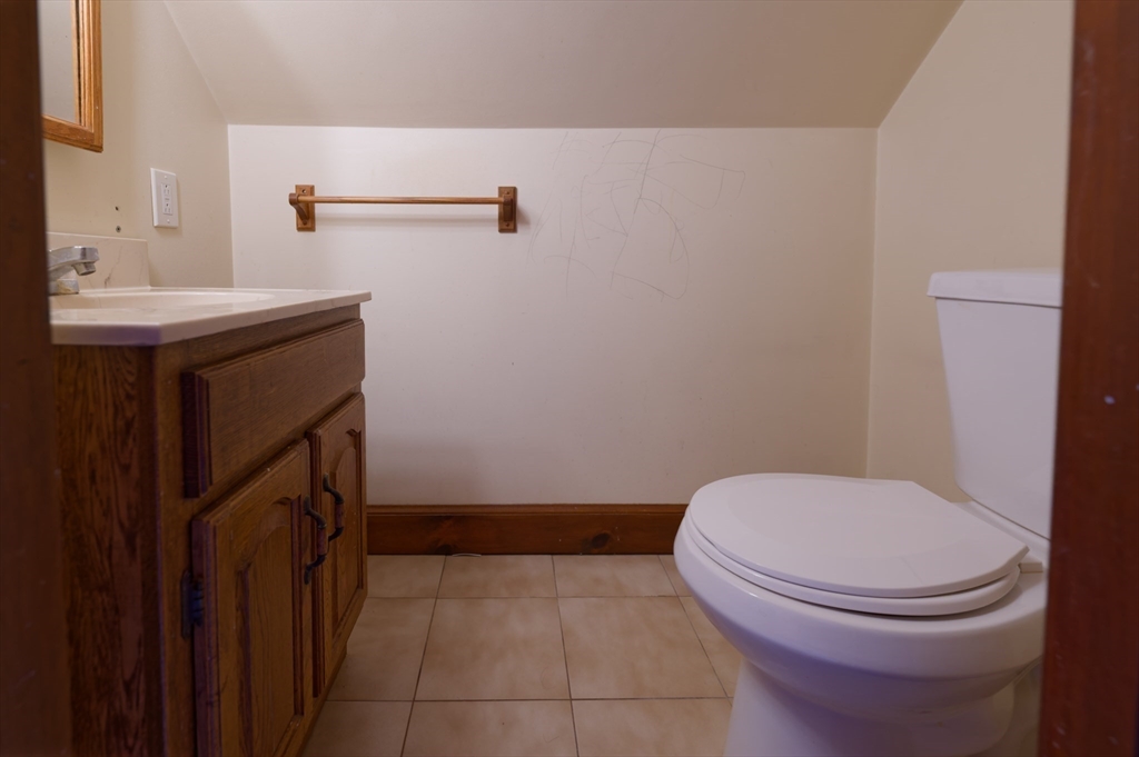 7 Cross Street Natick, MA 01760 - Photo 24 of 31 a bathroom with a sink a toilet and a mirror