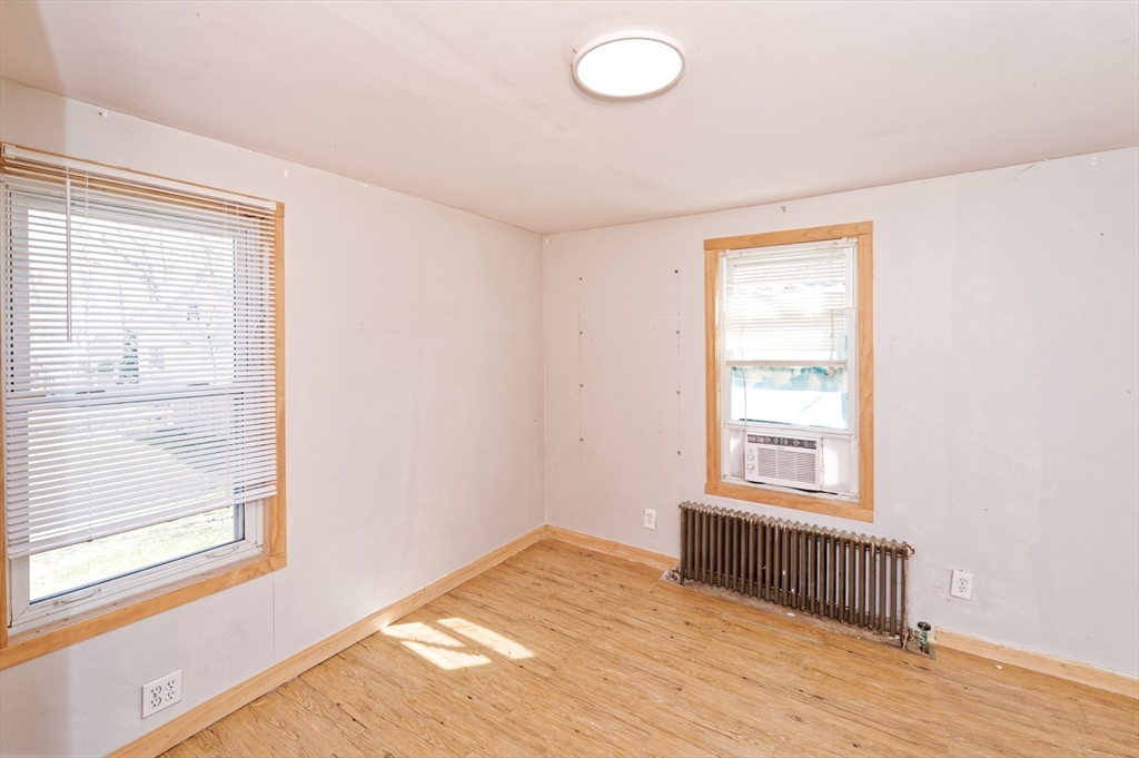7 Cross Street Natick, MA 01760 - Photo 8 of 31 a view of an empty room with wooden floor and a window