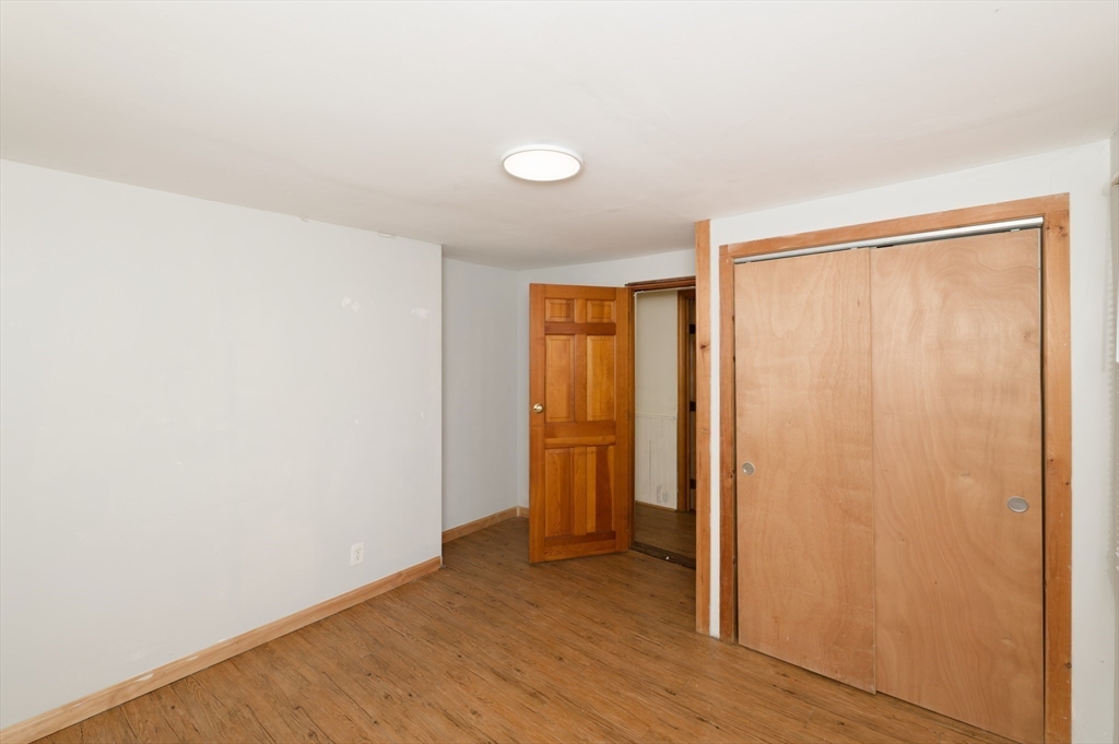 7 Cross Street Natick, MA 01760 - Photo 9 of 31 an empty room with wooden floor and sliding window