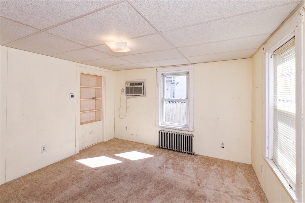 7 Cross Street Natick, MA 01760 - Photo 10 of 31 a view of an empty room with a window