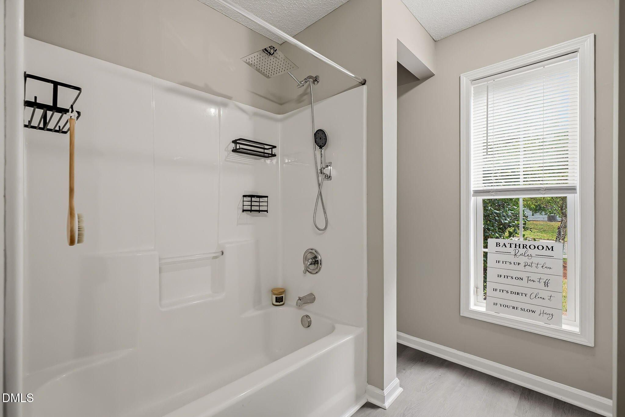 2501 Huntscroft Lane, Unit 100 Raleigh, NC 27617 - Photo 27 of 31 a bathroom with a bathtub a shower and a window