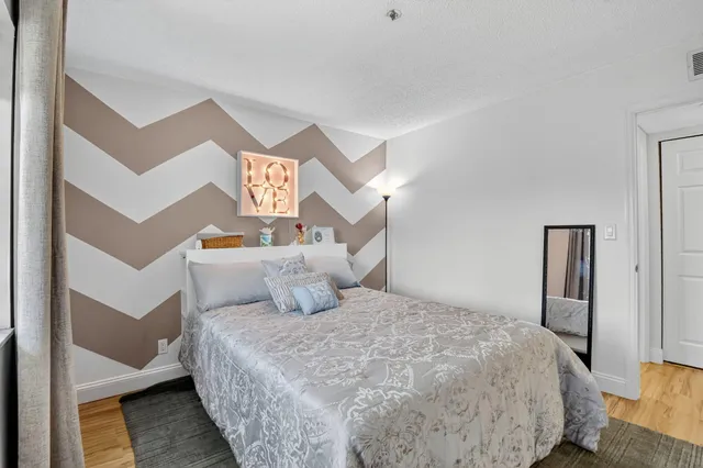 a bedroom with a bed and a night stand