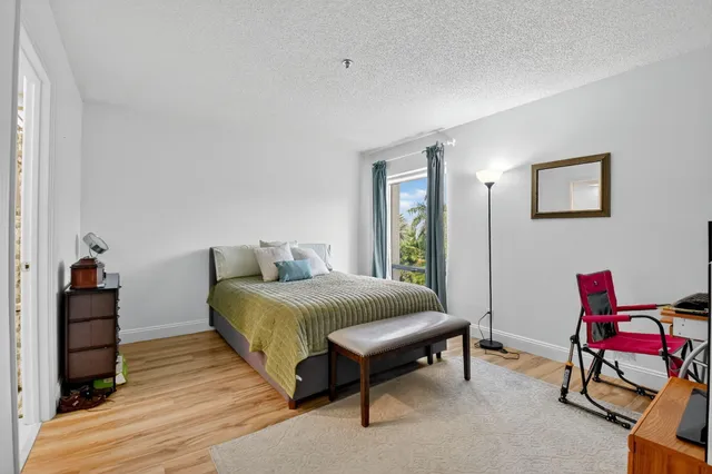 a bed room with a bed and a chair