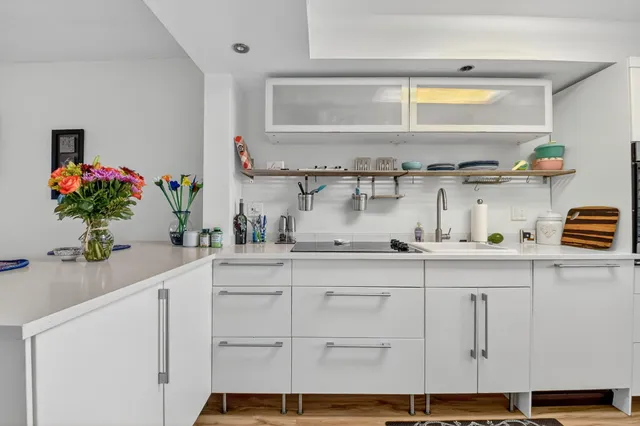 a kitchen with cabinets and window