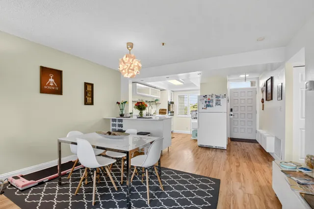 a dining room with furniture and wooden floor