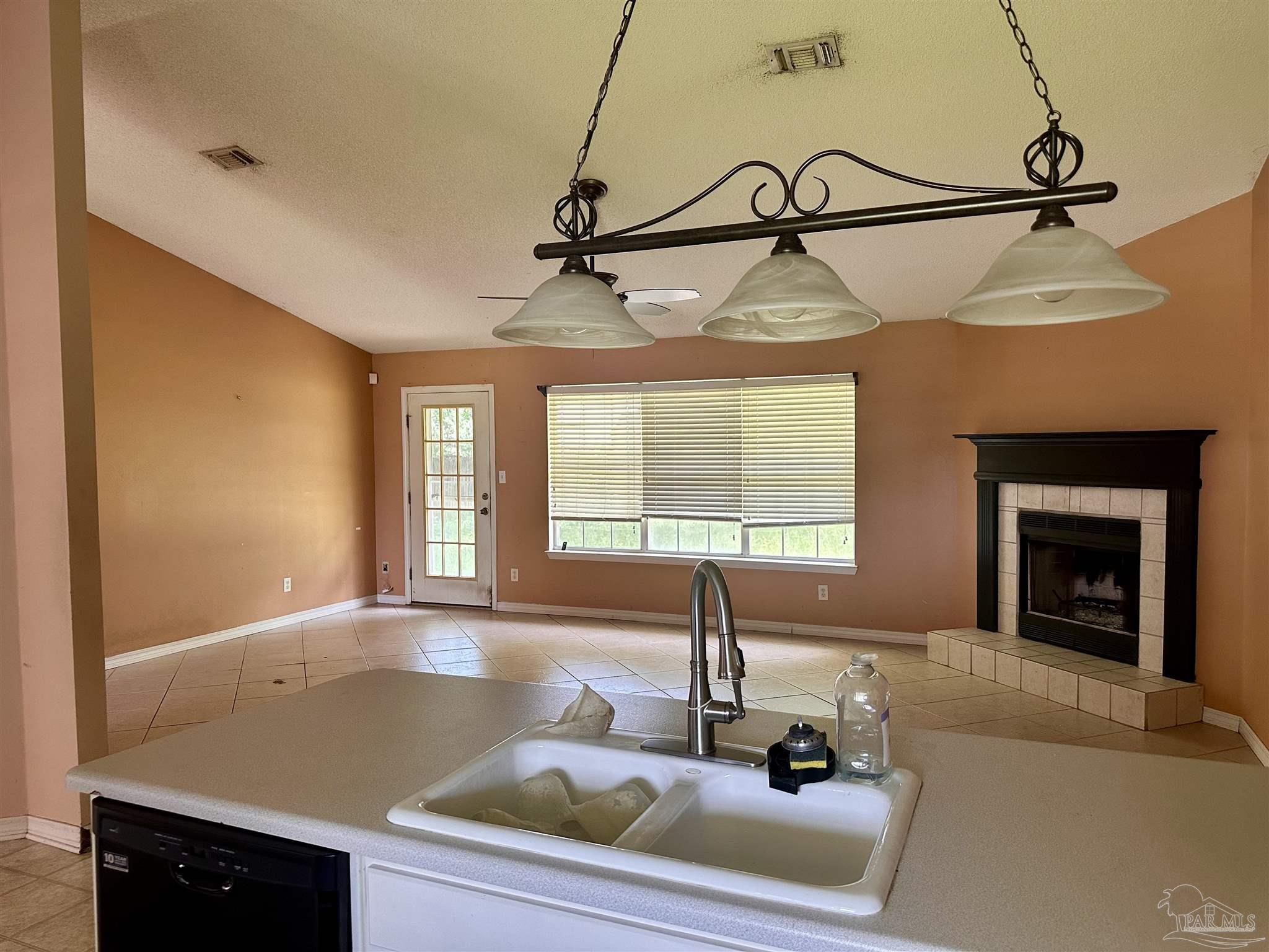 5582 Berrybrook Circle Pace, FL 32571 - Photo 4 of 15 a view of a room with a fireplace and windows