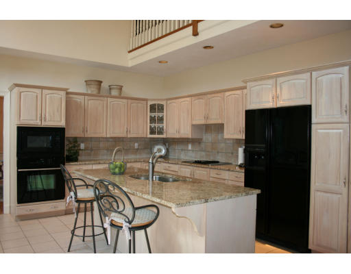 4 Amanda Road Sudbury, MA 01776 - Photo 8 of 29 a kitchen with kitchen island a counter top space cabinets and stainless steel appliances