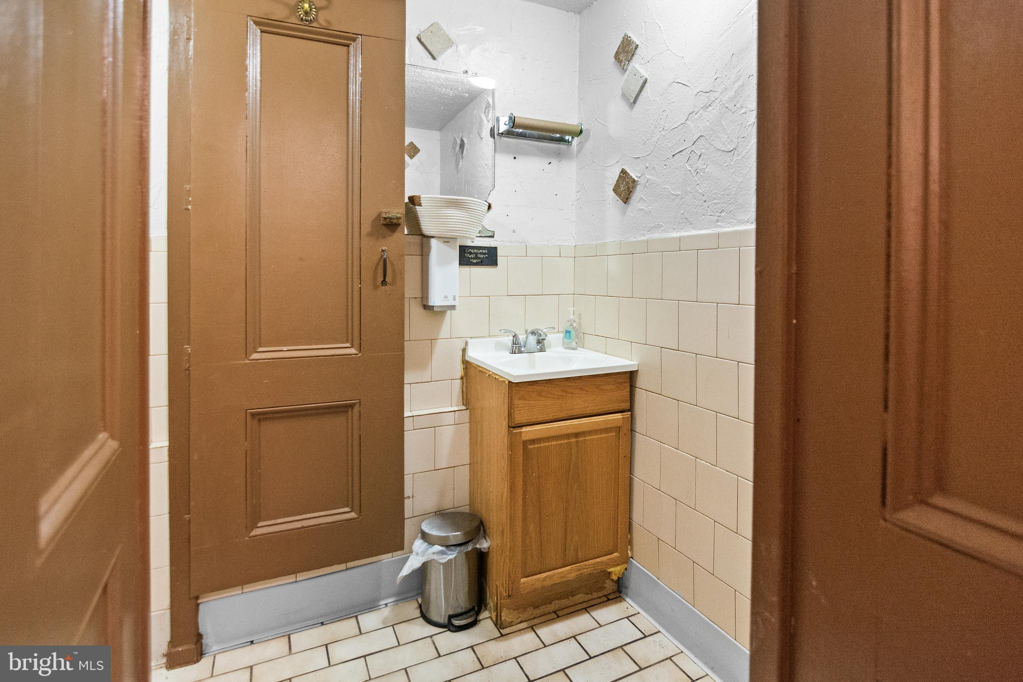 2112 Fleet Street Baltimore, MD 21231 - Photo 14 of 62 a bathroom with a sink a toilet and shower