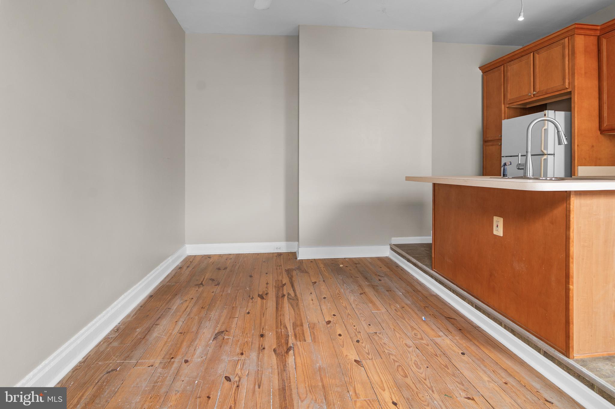 2112 Fleet Street Baltimore, MD 21231 - Photo 18 of 62 an empty room with wooden floor and a window