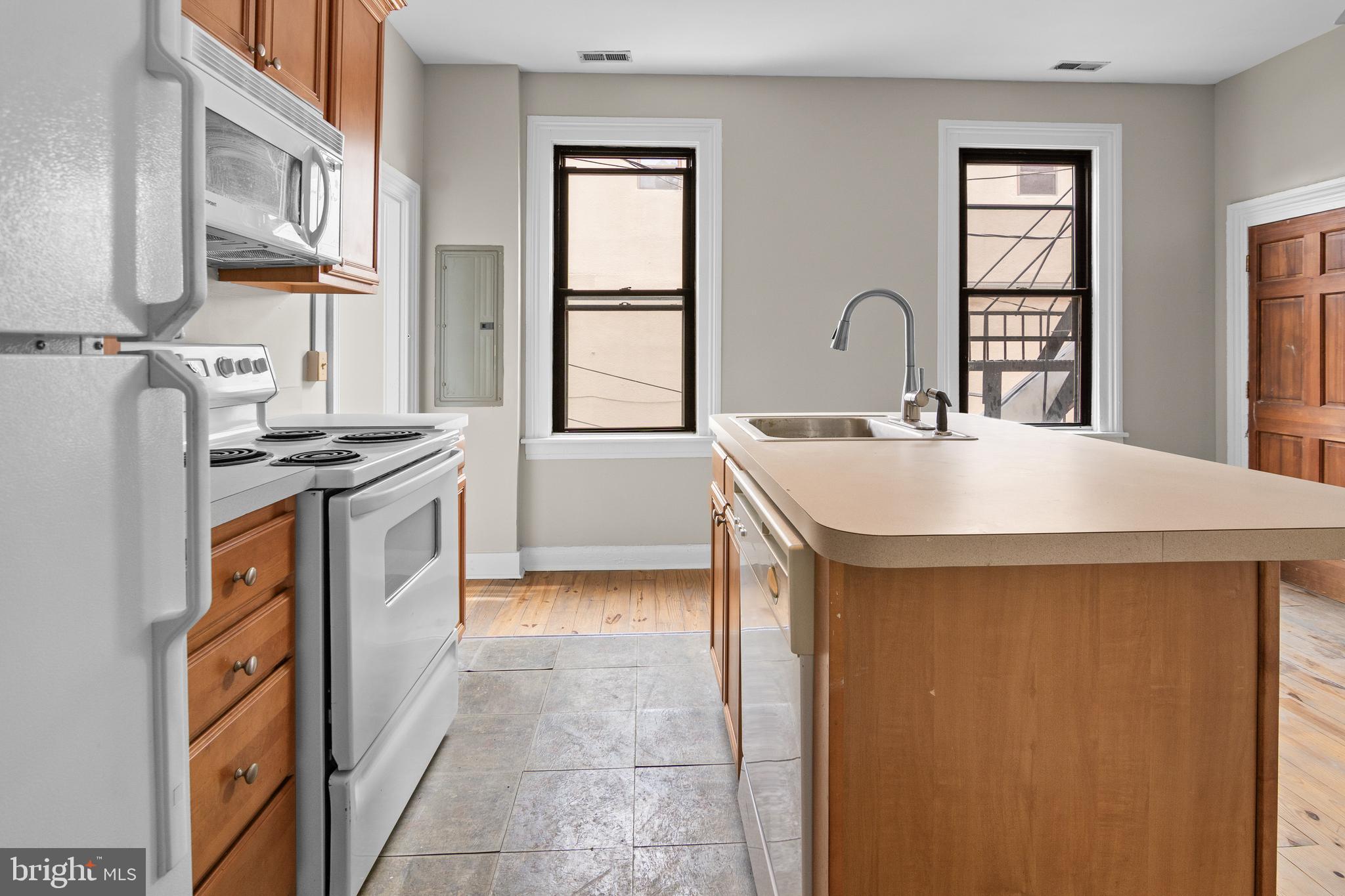 2112 Fleet Street Baltimore, MD 21231 - Photo 24 of 62 a kitchen with stainless steel appliances granite countertop a sink stove and refrigerator