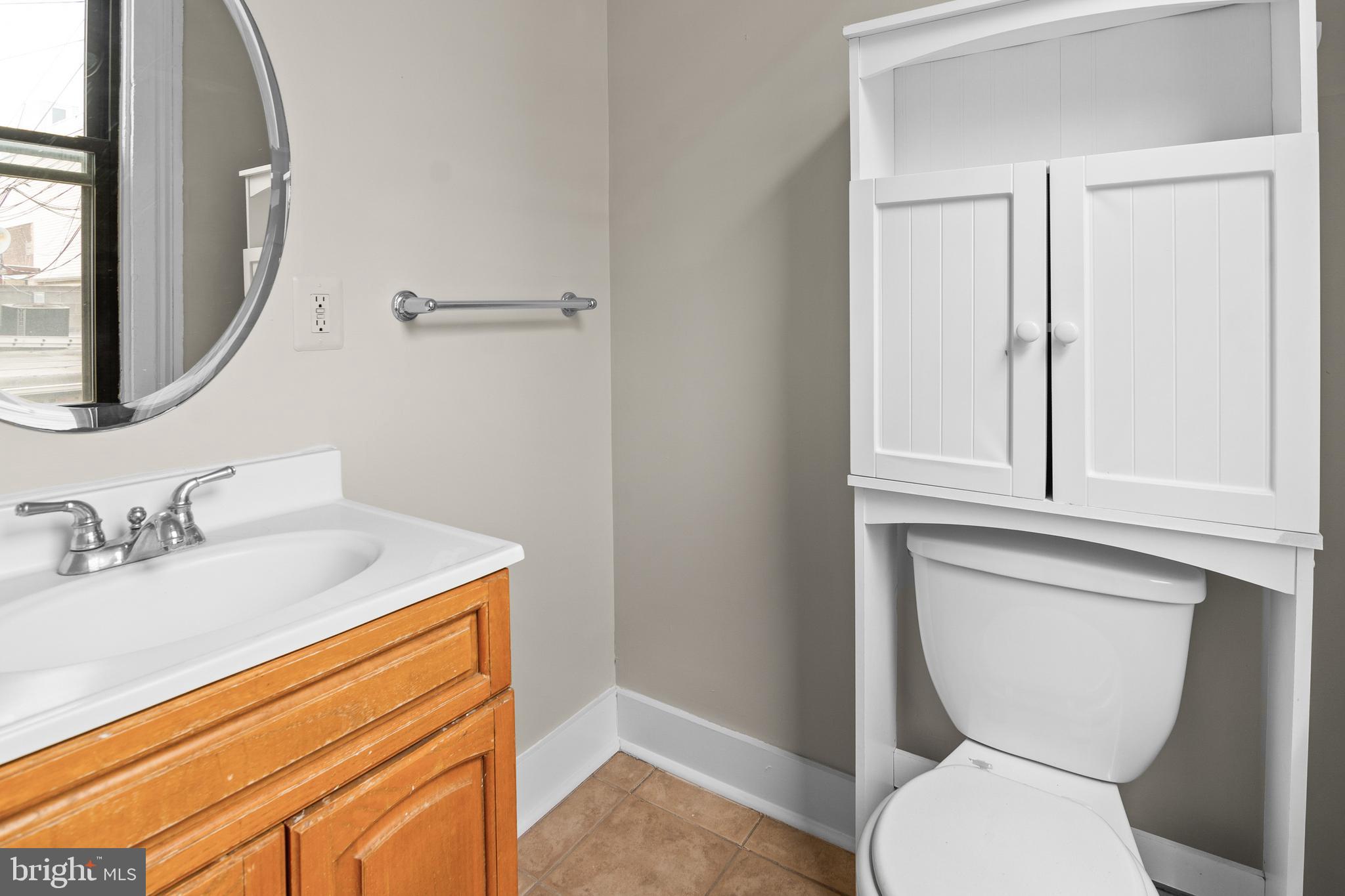 2112 Fleet Street Baltimore, MD 21231 - Photo 28 of 62 a bathroom with a toilet sink and mirror