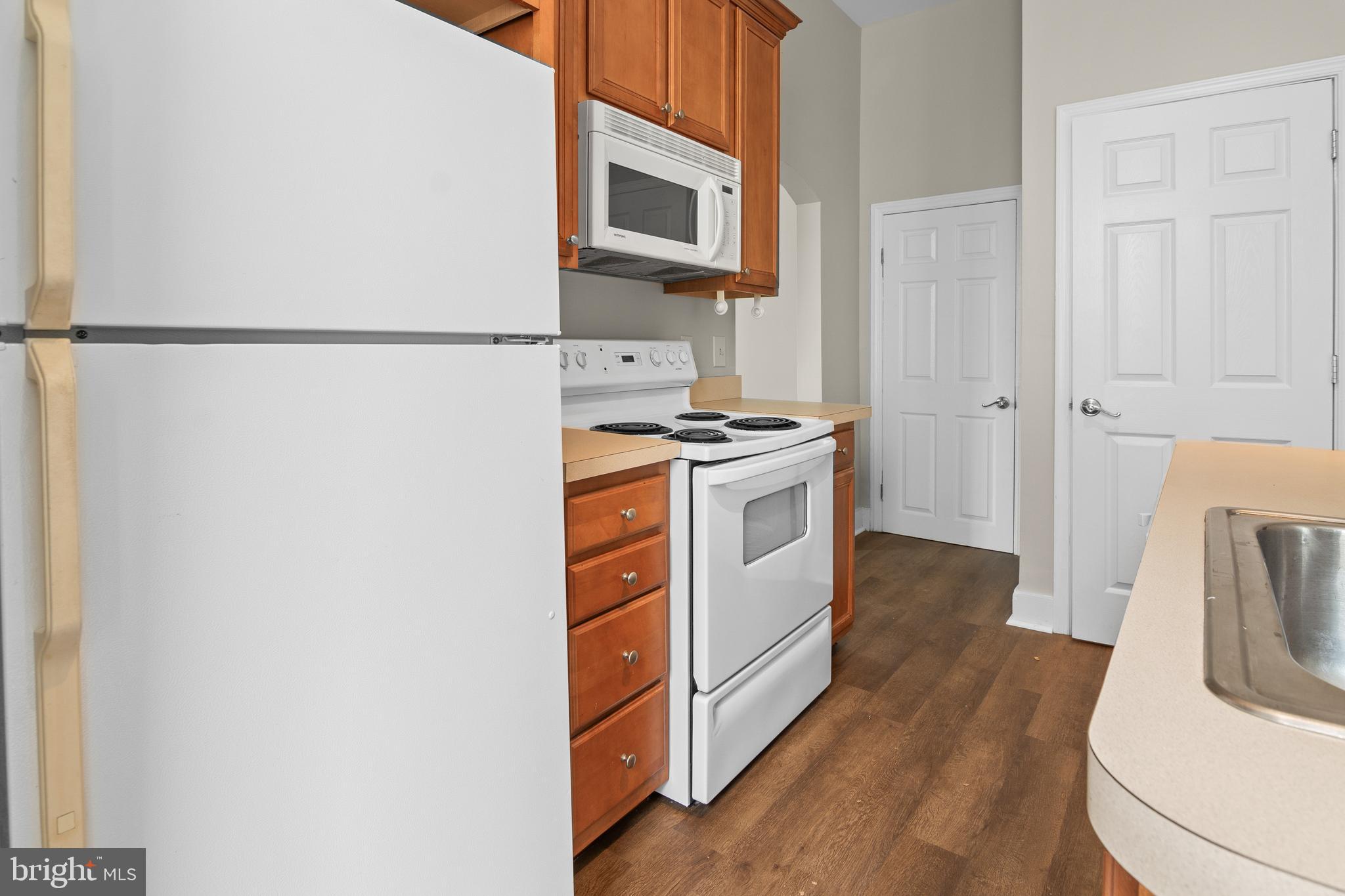 2112 Fleet Street Baltimore, MD 21231 - Photo 33 of 62 a kitchen with a stove a sink and a microwave