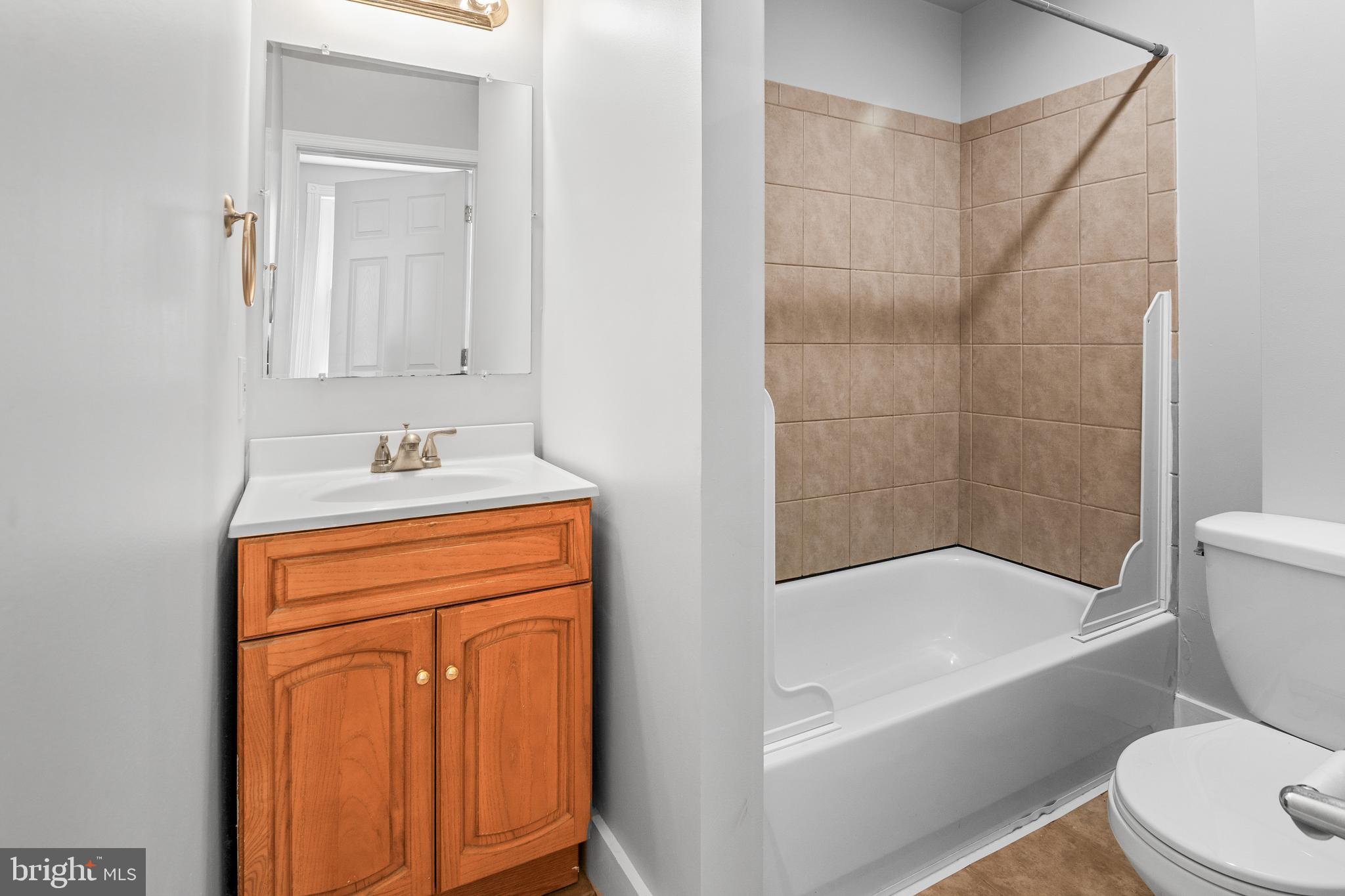 2112 Fleet Street Baltimore, MD 21231 - Photo 36 of 62 a bathroom with a granite countertop sink toilet and shower