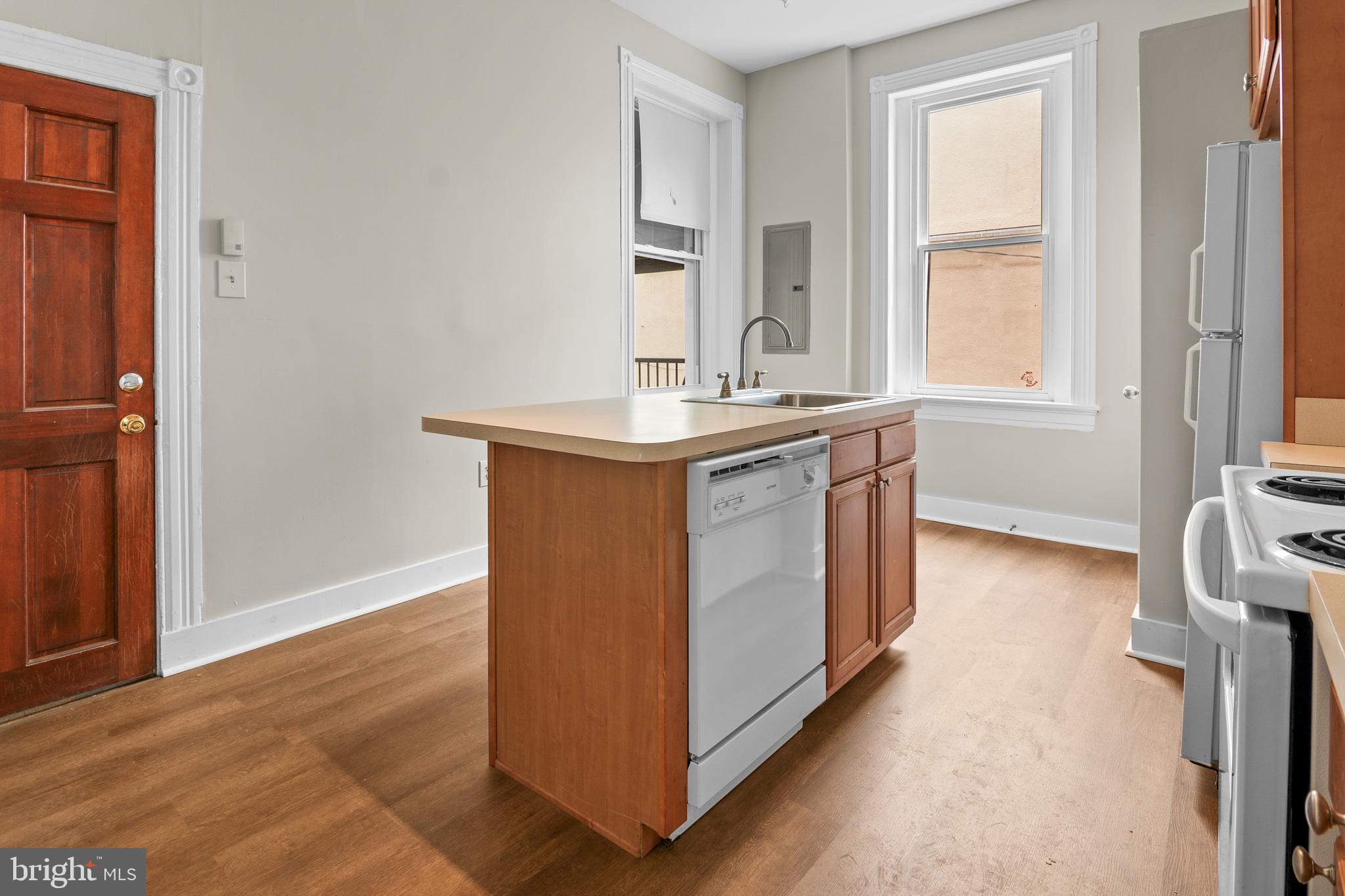 2112 Fleet Street Baltimore, MD 21231 - Photo 37 of 62 a kitchen with stainless steel appliances granite countertop a sink and a stove next to a window