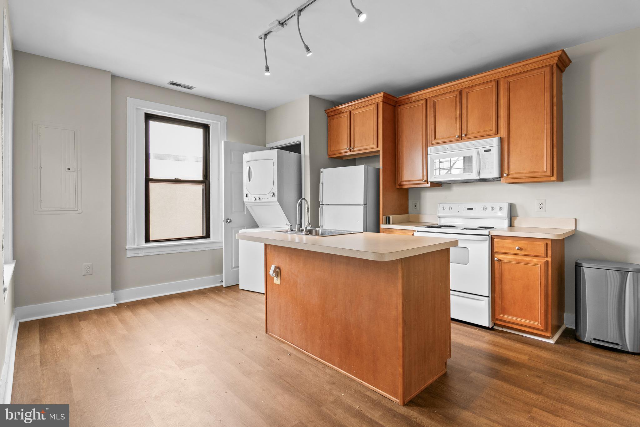 2112 Fleet Street Baltimore, MD 21231 - Photo 46 of 62 a kitchen with stainless steel appliances granite countertop a stove a sink dishwasher and a microwave oven with cabinets