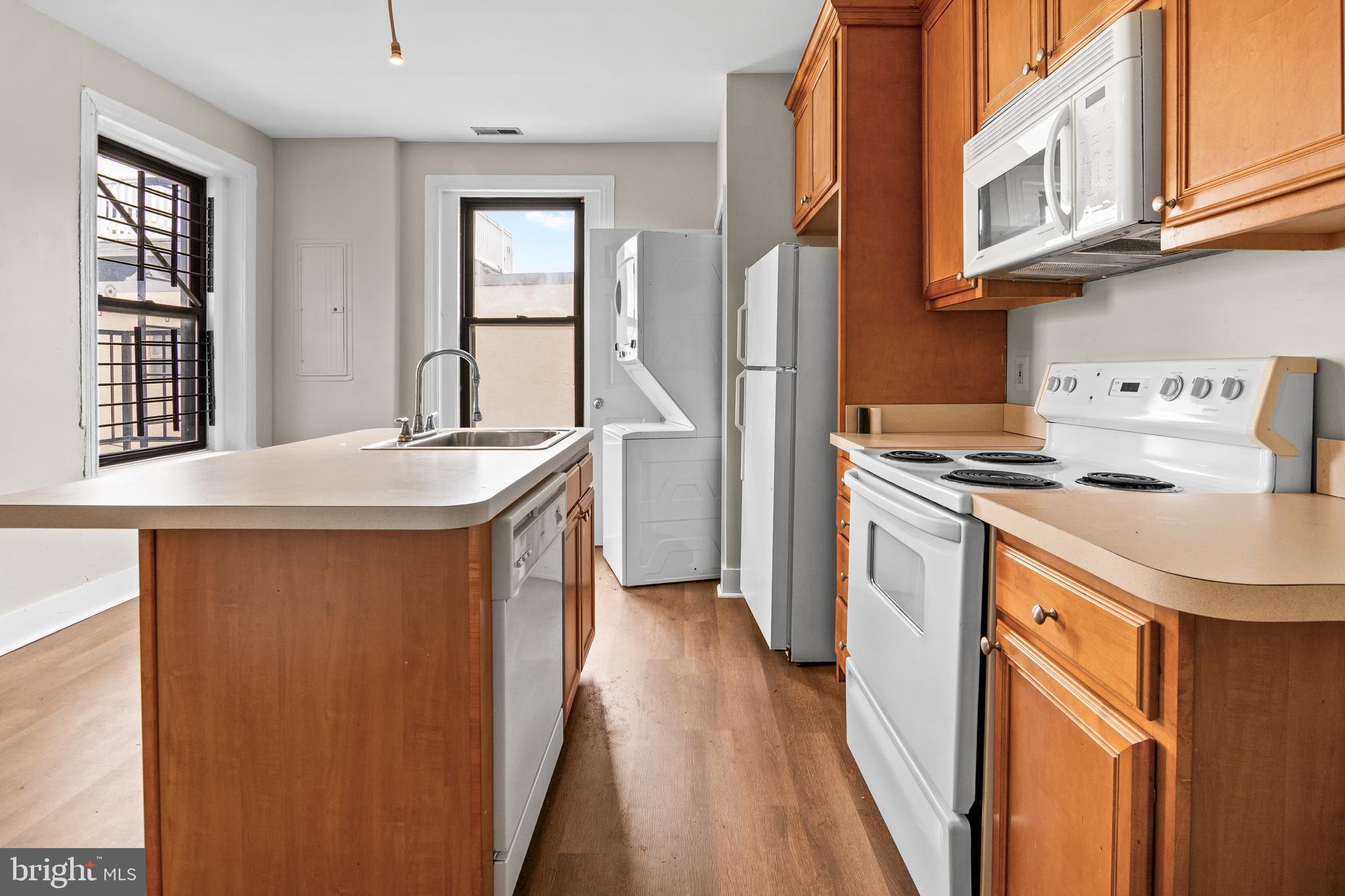 2112 Fleet Street Baltimore, MD 21231 - Photo 48 of 62 a kitchen with stainless steel appliances granite countertop a sink a stove and a refrigerator