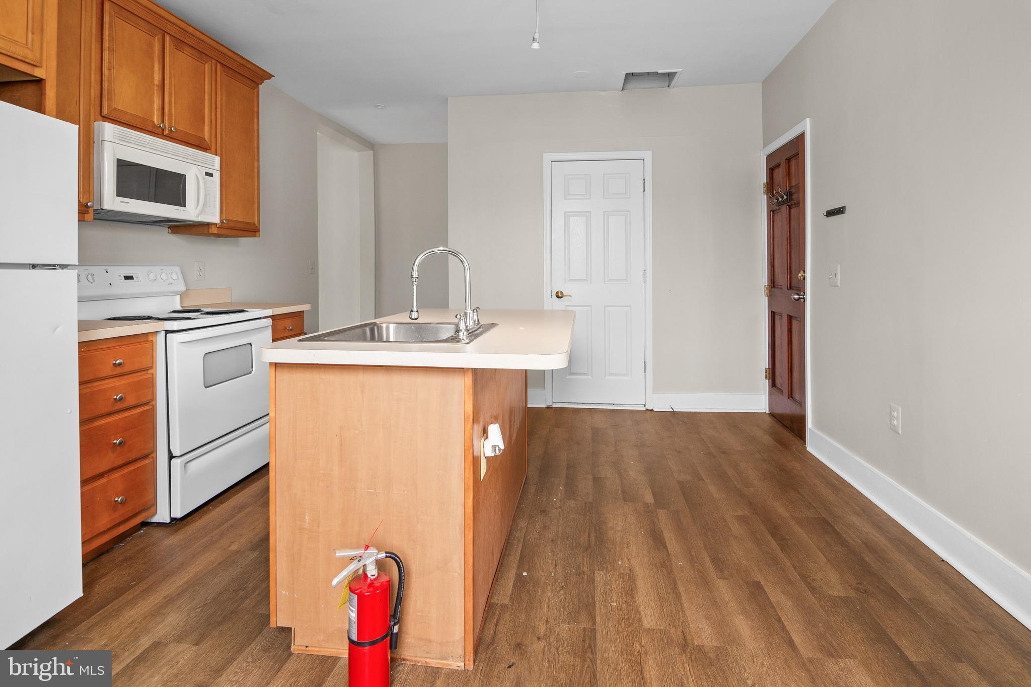 2112 Fleet Street Baltimore, MD 21231 - Photo 50 of 62 a kitchen with stainless steel appliances granite countertop a sink stove and wooden floor