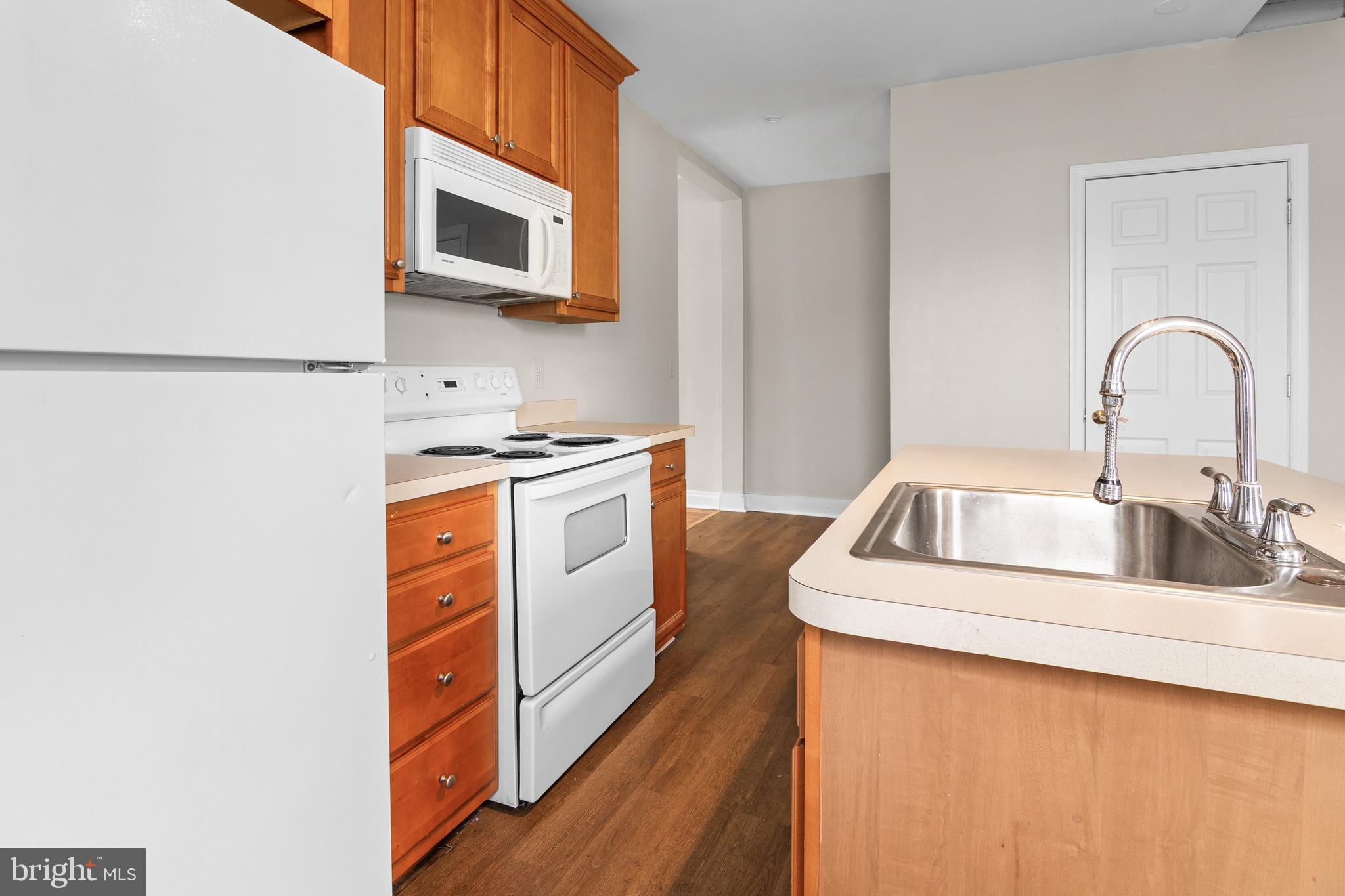 2112 Fleet Street Baltimore, MD 21231 - Photo 51 of 62 a kitchen with stainless steel appliances kitchen island a white stove top oven and sink