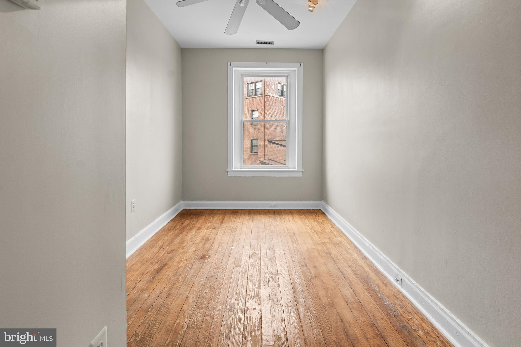 2112 Fleet Street Baltimore, MD 21231 - Photo 55 of 62 an empty room with wooden floor and windows