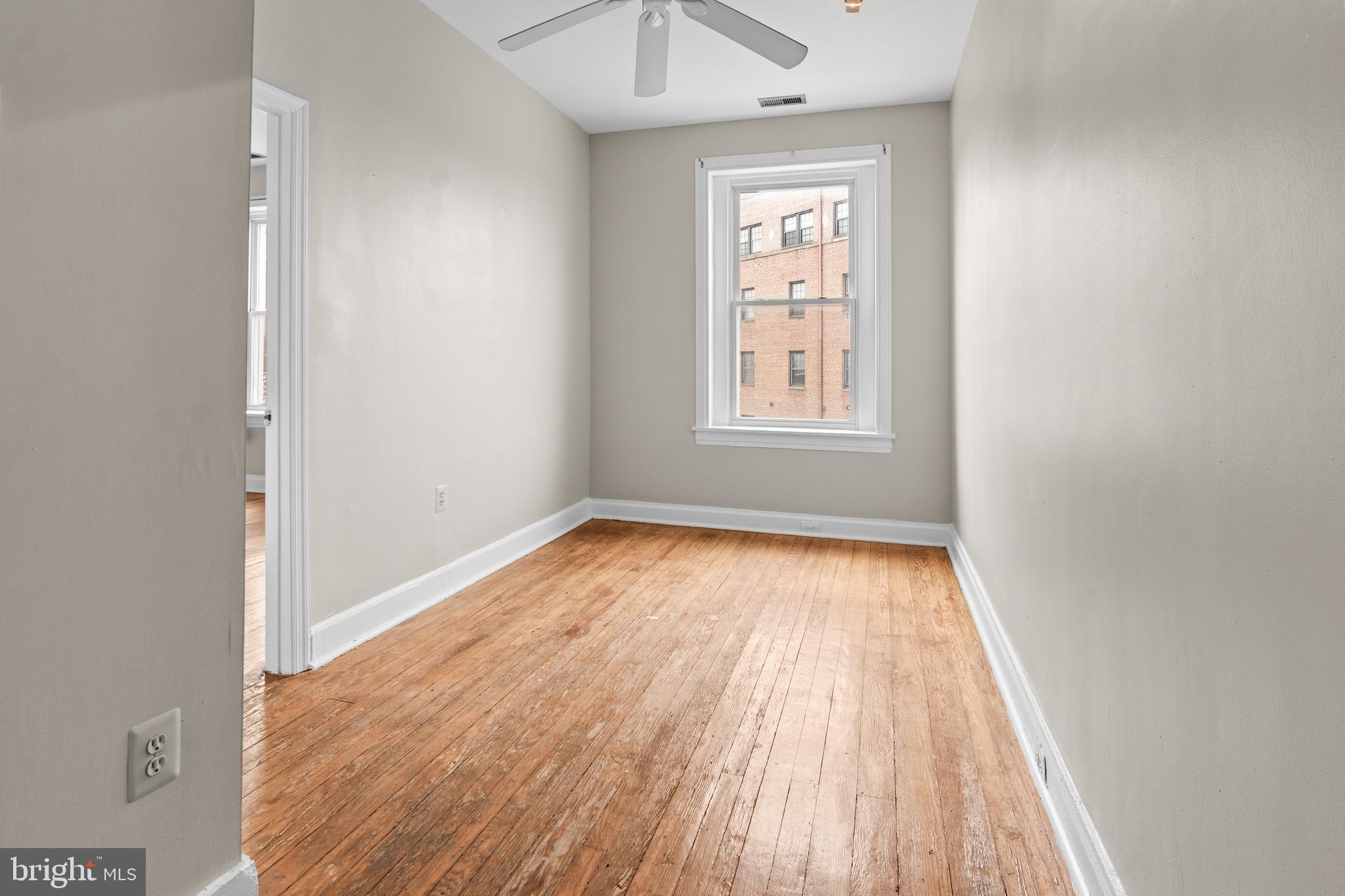 2112 Fleet Street Baltimore, MD 21231 - Photo 56 of 62 an empty room with wooden floor and windows