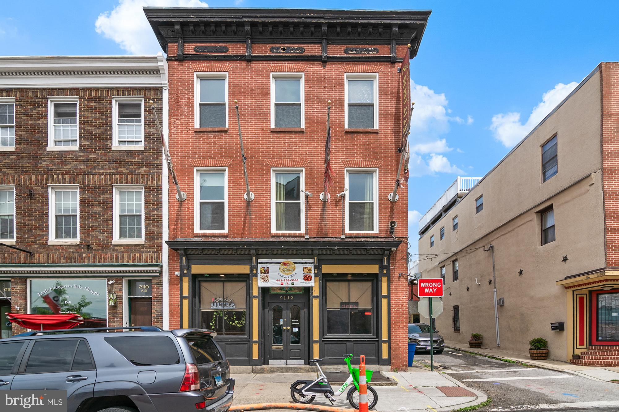 2112 Fleet Street Baltimore, MD 21231 - Photo 61 of 62 a front view of a building with cars parked