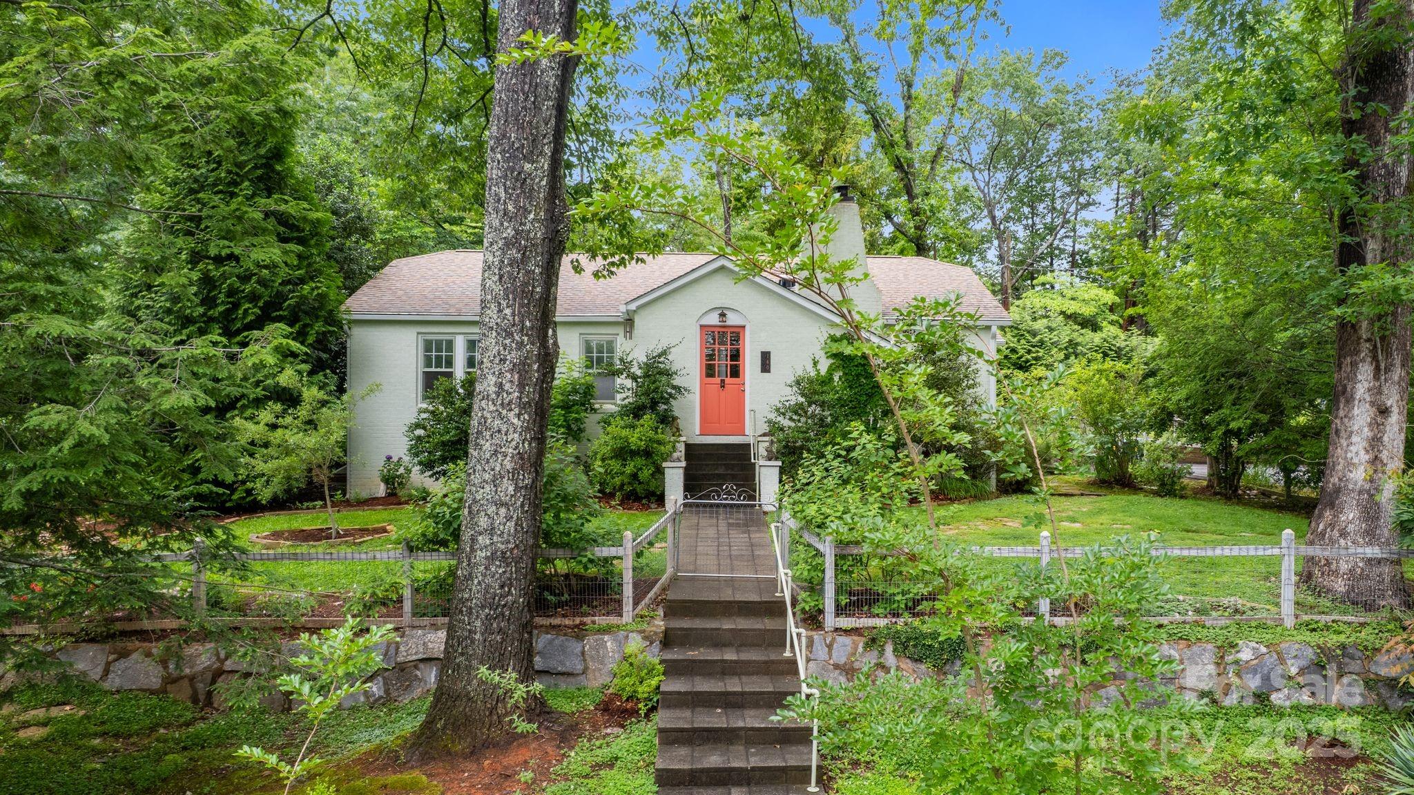 160 Hidden Hill Road Tryon, NC 28782 - Photo 1 of 47 a front view of a house with garden
