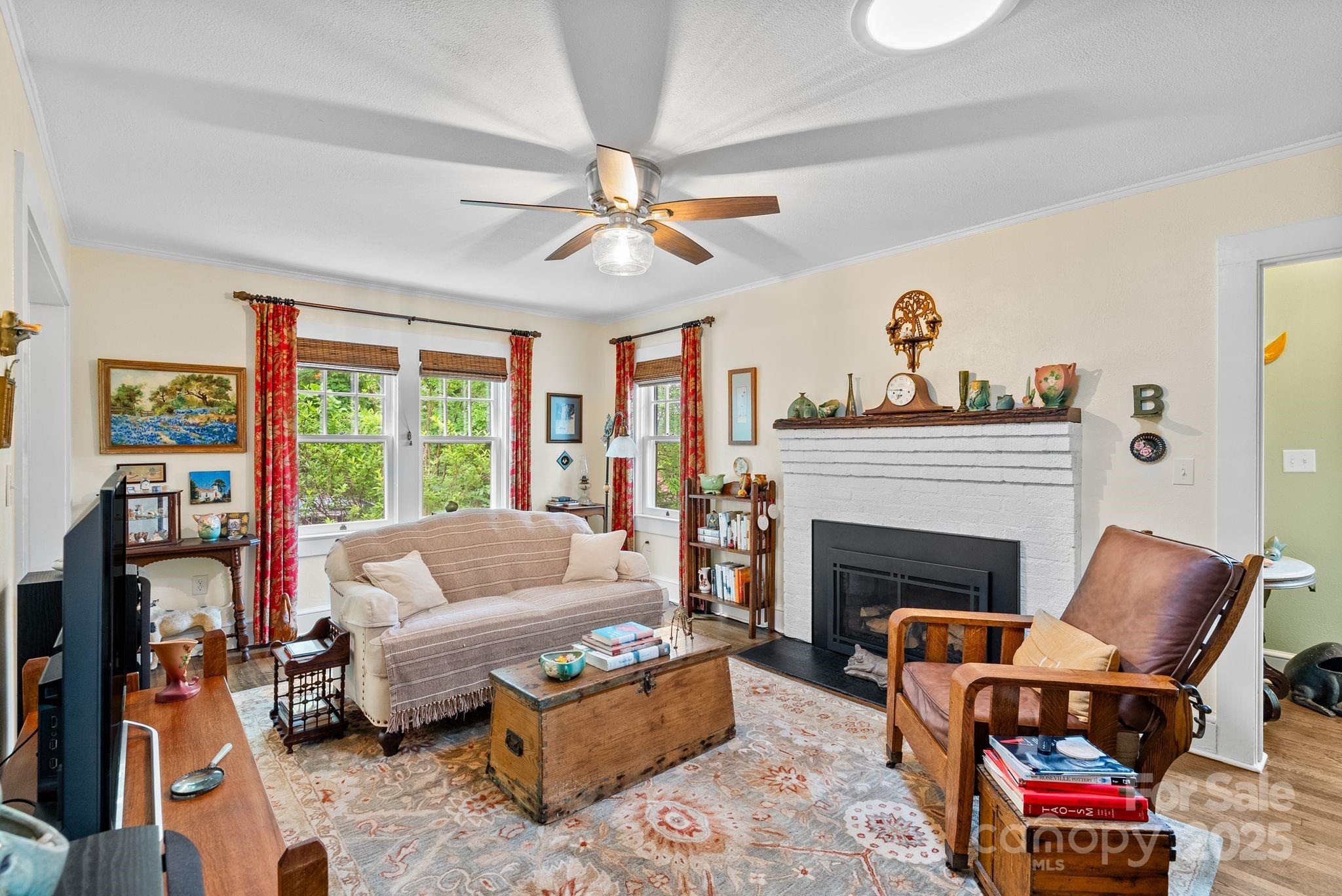 160 Hidden Hill Road Tryon, NC 28782 - Photo 12 of 47 a living room with furniture a fireplace and a large window