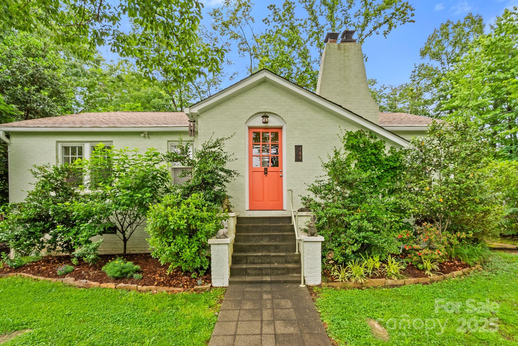 160 Hidden Hill Road Tryon, NC 28782 - Photo 2 of 47 a front view of a house with a yard and trees
