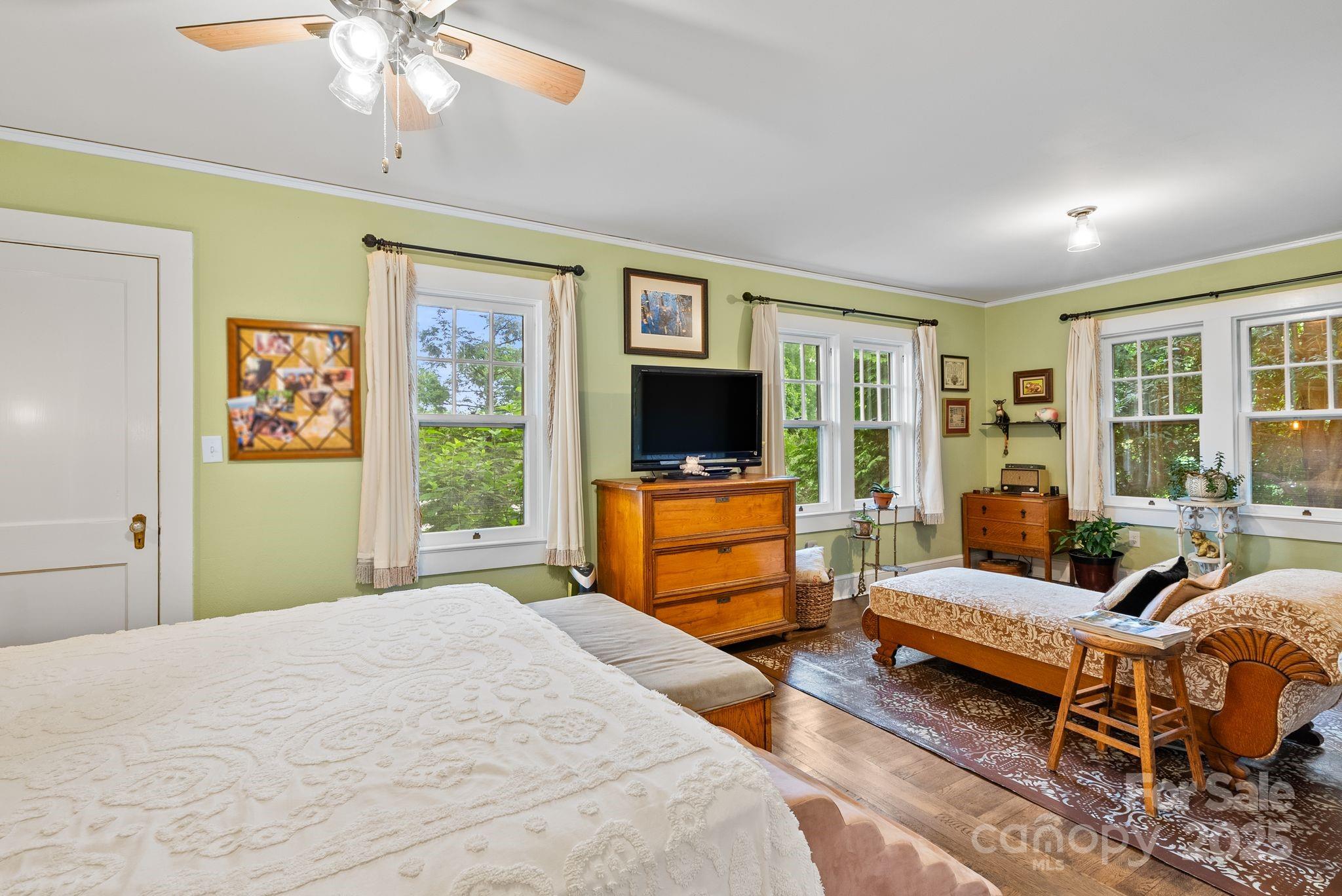 160 Hidden Hill Road Tryon, NC 28782 - Photo 23 of 47 a bedroom with a bed and large windows