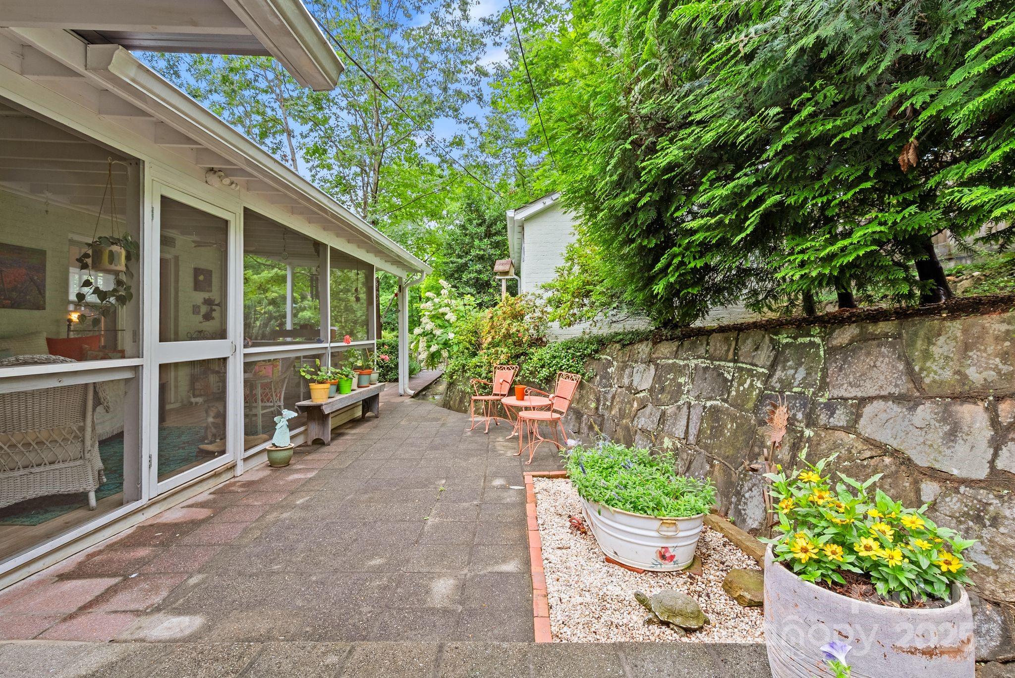 160 Hidden Hill Road Tryon, NC 28782 - Photo 39 of 47 a view of a chair and table in the backyard
