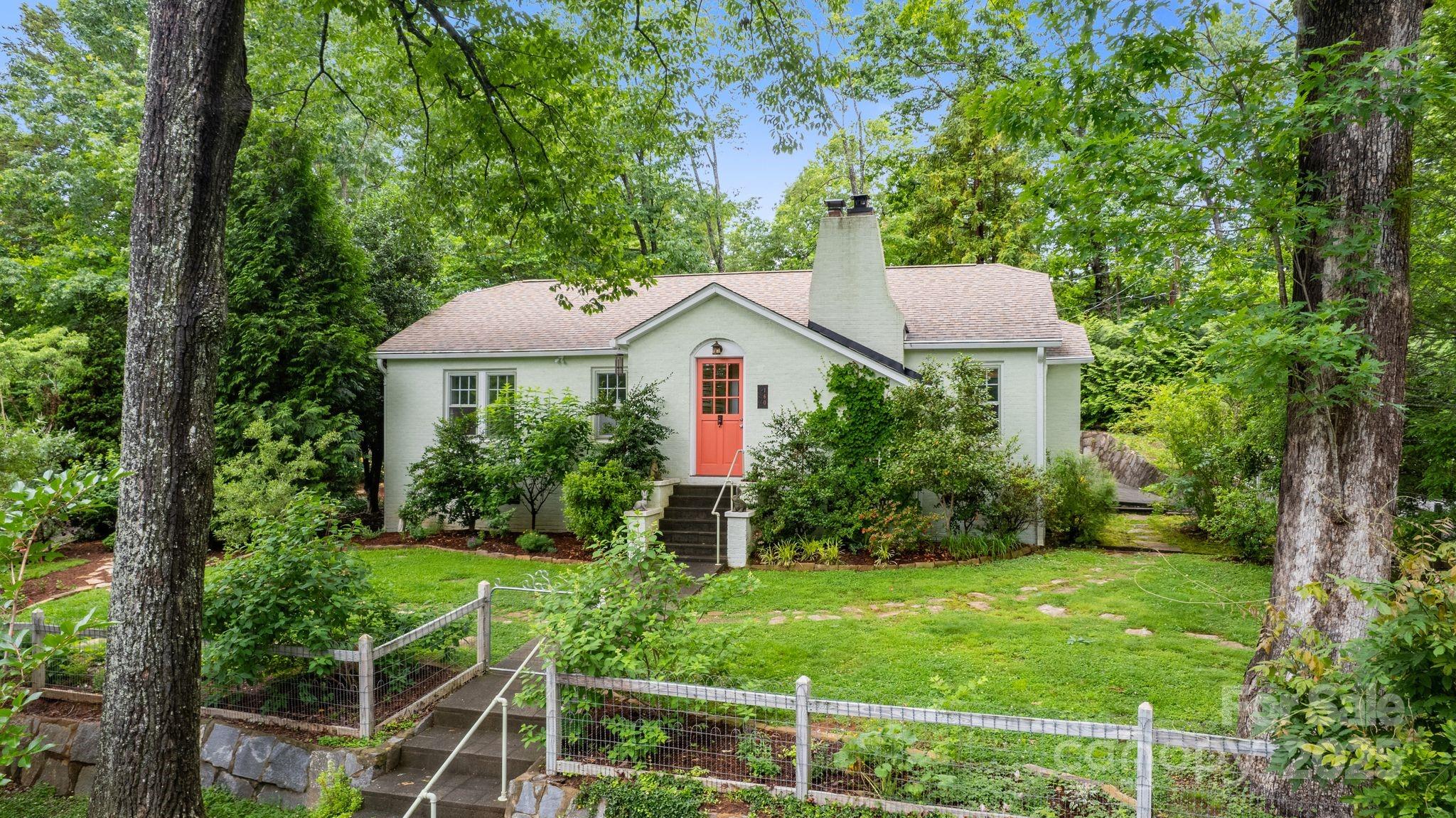 160 Hidden Hill Road Tryon, NC 28782 - Photo 4 of 47 a front view of a house with garden