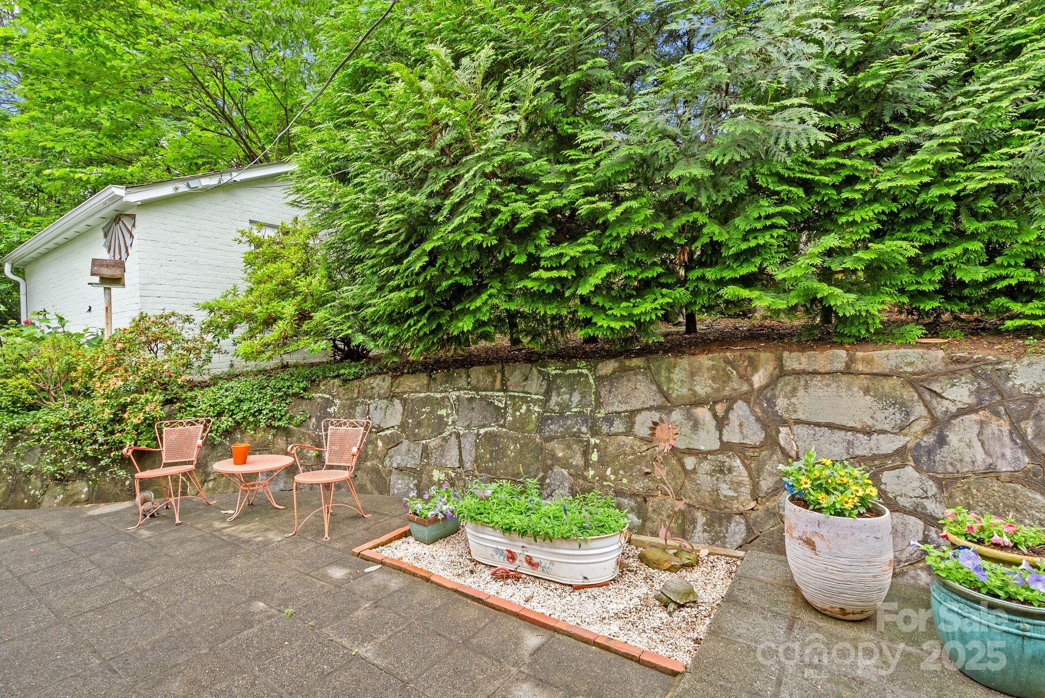 160 Hidden Hill Road Tryon, NC 28782 - Photo 41 of 47 a view of a backyard with patio and outdoor seating