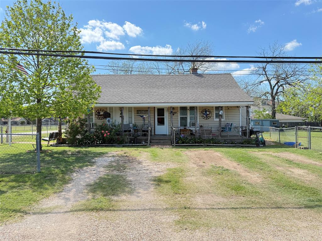 a front view of a house with a yard and outdoor seating