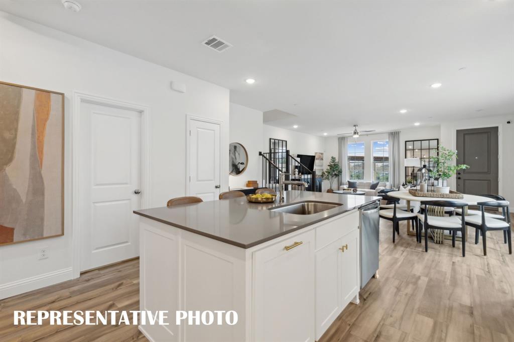 1005 Splitrock Drive Allen, TX 75013 - Photo 6 of 15 a kitchen with a sink appliances and wooden floor