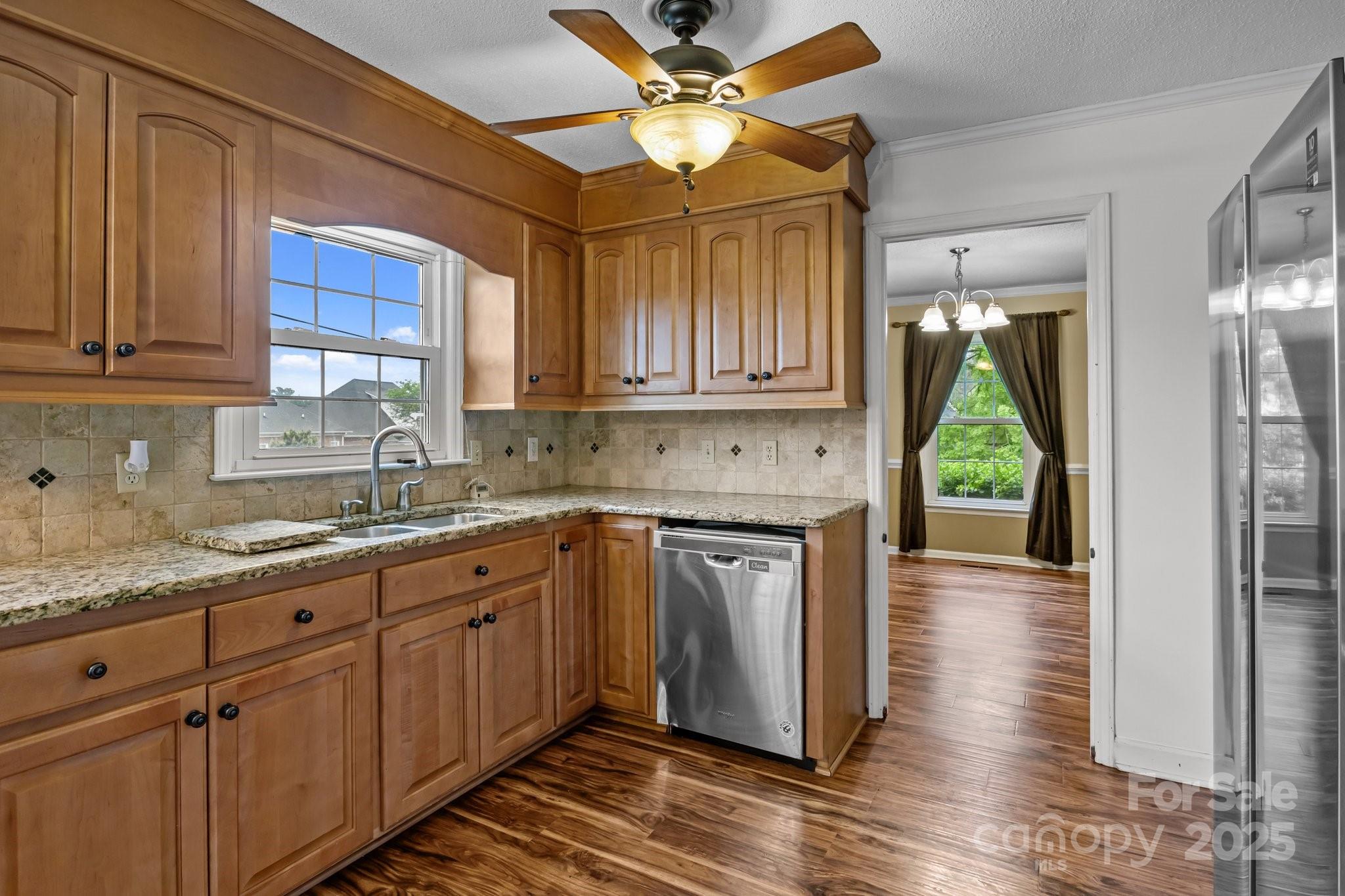 101 Wynnchester Road Gastonia, NC 28056 - Photo 11 of 46 a kitchen with kitchen island granite countertop a sink a counter space appliances and cabinets