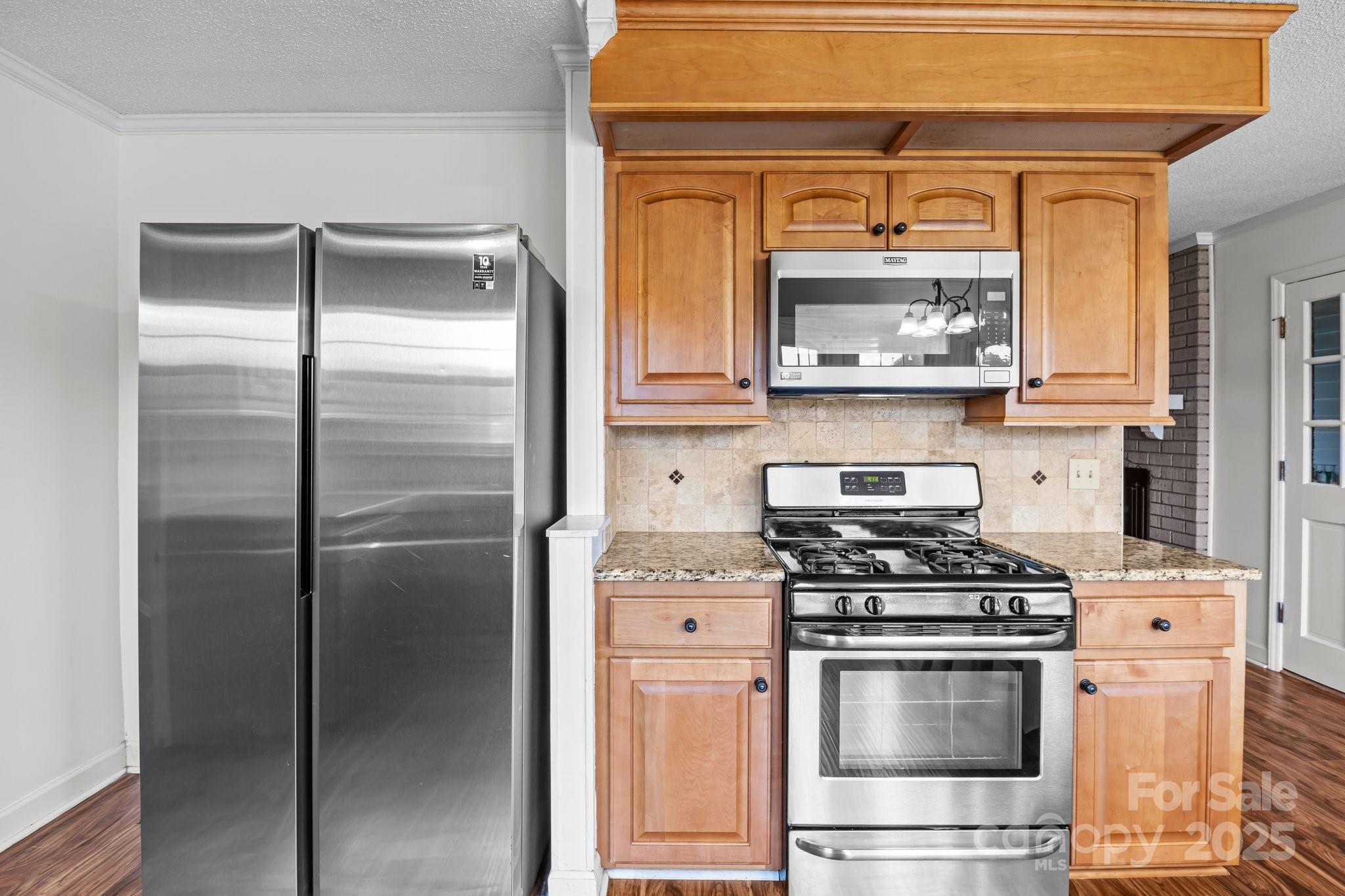 101 Wynnchester Road Gastonia, NC 28056 - Photo 12 of 46 a kitchen with stainless steel appliances granite countertop a refrigerator and a stove top oven