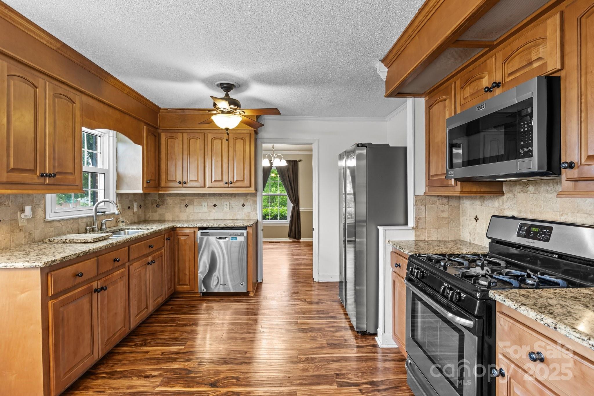101 Wynnchester Road Gastonia, NC 28056 - Photo 13 of 46 a kitchen with stainless steel appliances granite countertop a stove top oven a refrigerator a sink and dishwasher