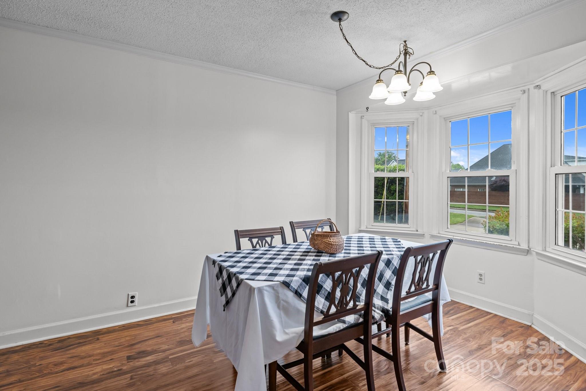 101 Wynnchester Road Gastonia, NC 28056 - Photo 16 of 46 a view of a dining room with furniture a chandelier and wooden floor