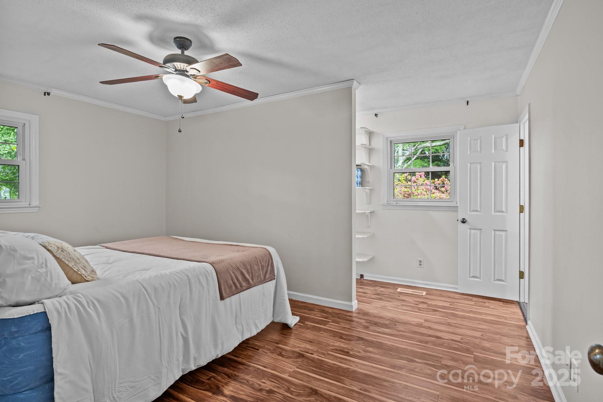 101 Wynnchester Road Gastonia, NC 28056 - Photo 23 of 46 a bedroom with a bed and a chandelier