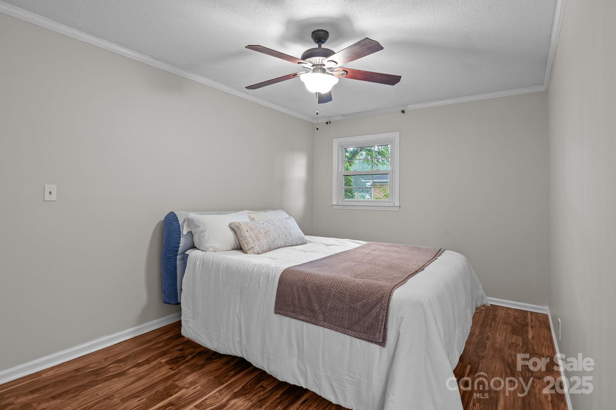 101 Wynnchester Road Gastonia, NC 28056 - Photo 24 of 46 a bedroom with bed and a chandelier