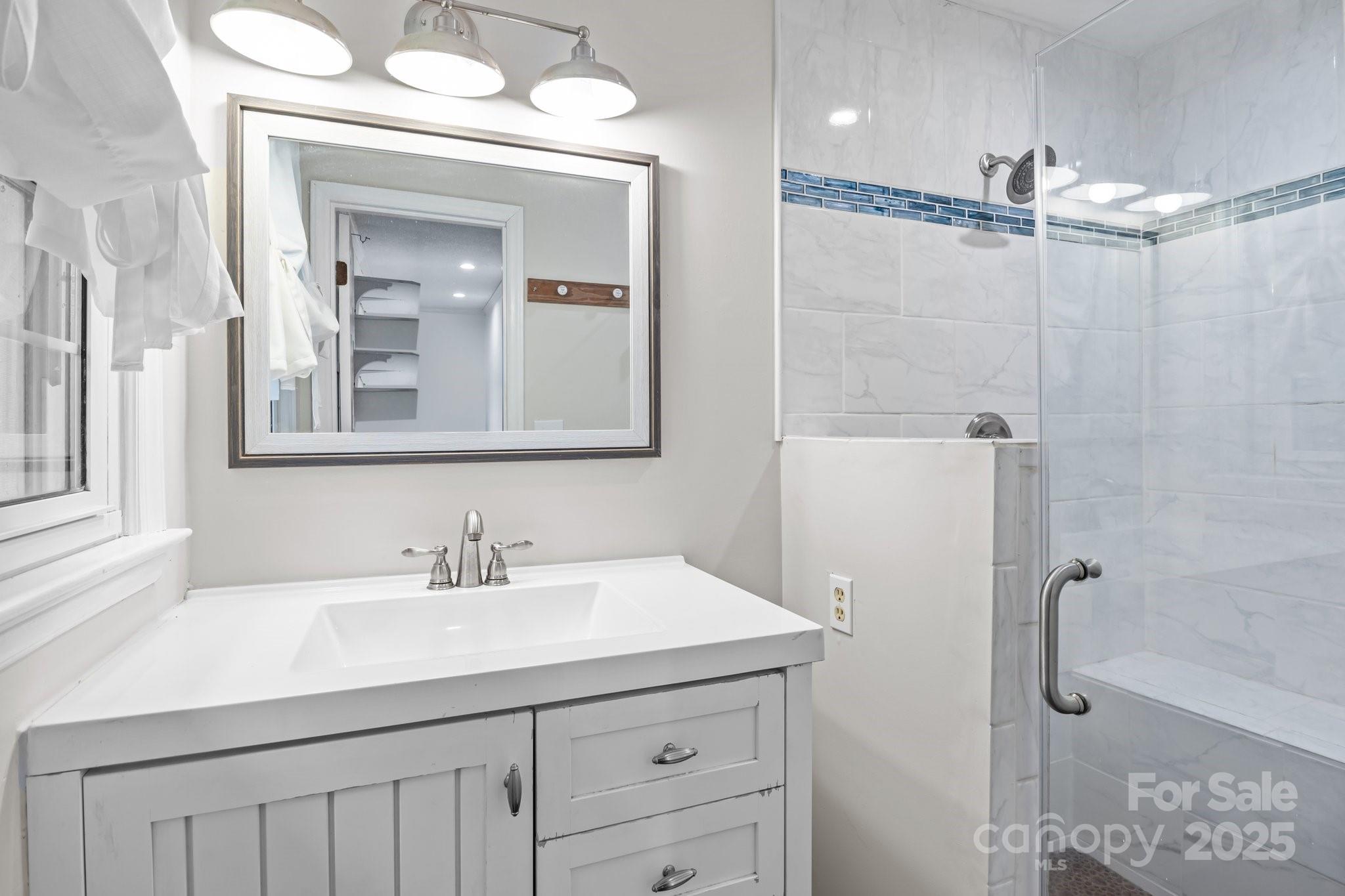 101 Wynnchester Road Gastonia, NC 28056 - Photo 26 of 46 a bathroom with a sink a mirror a vanity and shower