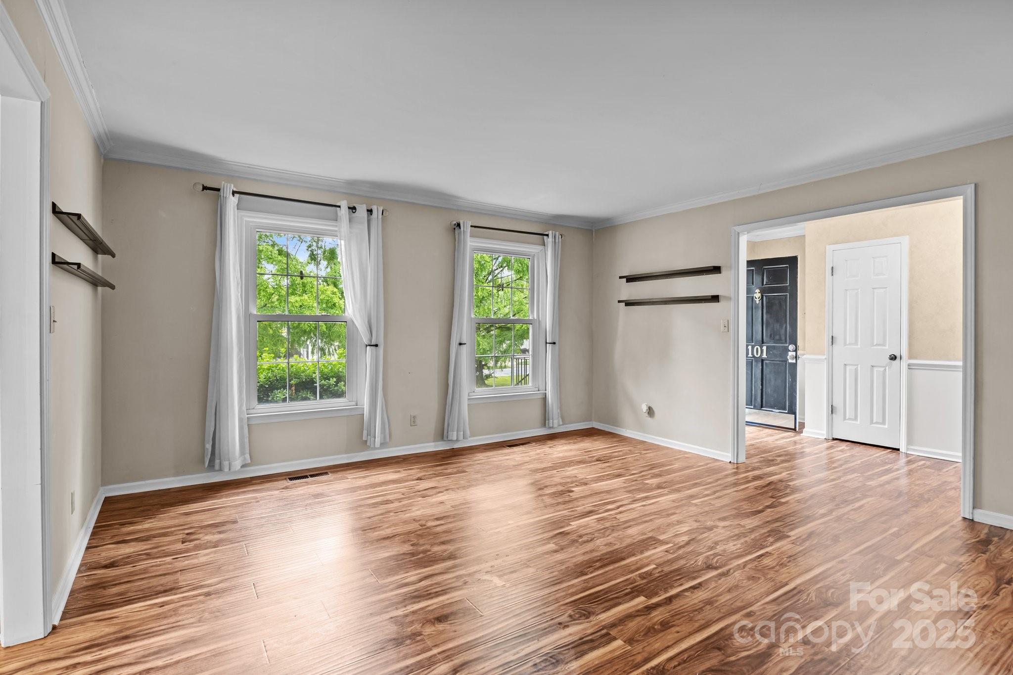 101 Wynnchester Road Gastonia, NC 28056 - Photo 6 of 46 a view of an empty room with wooden floor and a window